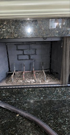 Gas fireplace ember bed and burner cleaned during a service