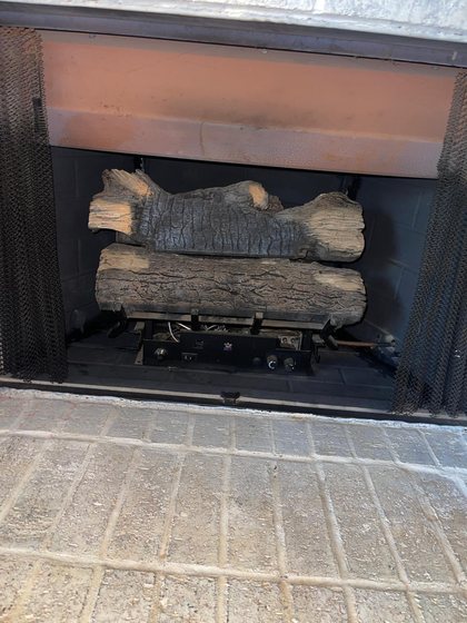Gas logs set back in place after the firebox and burner were cleaned